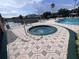 Enjoy this outdoor hot tub with patterned deck, metal railing, and community amenities, perfect for relaxation and leisure at 2202 Key West Ct # 633, Kissimmee, FL 34741