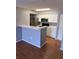 Modern kitchen with stainless steel appliances, white cabinets, and a breakfast bar at 2202 Key West Ct # 633, Kissimmee, FL 34741
