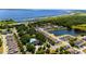 Overhead view of residential neighborhood with mature trees, community pool and scenic lake at 2340 Grasmere View S Pkwy, Kissimmee, FL 34746