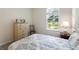 Bright bedroom features carpeted floors, a window with blinds, and a dresser for storage at 2340 Grasmere View S Pkwy, Kissimmee, FL 34746
