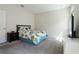 Serene bedroom with a leafy patterned comforter, plush carpet, and bright, natural light at 2340 Grasmere View S Pkwy, Kissimmee, FL 34746