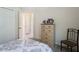 This bedroom includes carpeted floors, a large closet, a patterned comforter, and a chair for relaxation at 2340 Grasmere View S Pkwy, Kissimmee, FL 34746