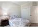 This bedroom includes carpeted floors, a large closet, a patterned comforter, and a side table with a lamp at 2340 Grasmere View S Pkwy, Kissimmee, FL 34746