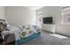 Cozy bedroom with plush carpet, large windows, and a neutral color scheme at 2340 Grasmere View S Pkwy, Kissimmee, FL 34746
