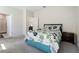 Well-lit bedroom with plush carpet and view into en suite bathroom at 2340 Grasmere View S Pkwy, Kissimmee, FL 34746