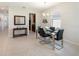 Bright dining area featuring modern table set, chandelier, and sleek tiled floors at 2340 Grasmere View S Pkwy, Kissimmee, FL 34746
