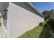 Exterior shot of the home showing the side wall, grass, and attached garage at 2340 Grasmere View S Pkwy, Kissimmee, FL 34746