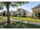 Well-manicured lawn and landscaped garden compliment this modern single-story home at 2340 Grasmere View S Pkwy, Kissimmee, FL 34746