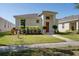 Charming single-story home featuring a well-maintained lawn and colorful landscaping at 2340 Grasmere View S Pkwy, Kissimmee, FL 34746