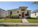 Inviting single-story home boasts fresh landscaping, a vibrant front door, and bright curb appeal at 2340 Grasmere View S Pkwy, Kissimmee, FL 34746