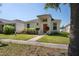 Inviting single-story home boasts fresh landscaping, a vibrant front door, and bright curb appeal at 2340 Grasmere View S Pkwy, Kissimmee, FL 34746