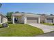 Attractive single-story home with a spacious two car garage and cozy front porch at 2340 Grasmere View S Pkwy, Kissimmee, FL 34746