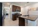 Open kitchen with granite counters, stainless steel appliances, and view to dining room at 2340 Grasmere View S Pkwy, Kissimmee, FL 34746
