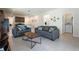 Open concept living room view showing kitchen, dining area, and access to laundry room at 2340 Grasmere View S Pkwy, Kissimmee, FL 34746