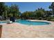 Large, inviting pool with a brick paved deck area, lounge chairs and beautiful landscape at 2340 Grasmere View S Pkwy, Kissimmee, FL 34746