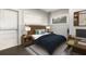 Well-lit bedroom with a wooden bed frame, minimalist decor, desk, and natural light at 2504 Yale Ave, Sanford, FL 32773