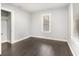 Neutral bedroom features dark floors, light walls, and two windows, plus a walk-in closet at 2504 Yale Ave, Sanford, FL 32773
