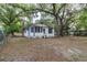 Home exterior with screened porch and lush trees at 2504 Yale Ave, Sanford, FL 32773