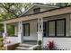 Inviting front porch with decorative columns, contrasting trim, and landscaped garden beds at 2504 Yale Ave, Sanford, FL 32773
