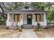Charming single-story home with a welcoming front porch, garden beds, and a well-manicured yard at 2504 Yale Ave, Sanford, FL 32773