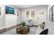 Bright living room featuring a cozy seating area with natural light, modern decor, and hardwood floors at 2504 Yale Ave, Sanford, FL 32773