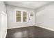 Bright living room with dark hardwood floors, fresh gray paint, and natural light from large windows at 2504 Yale Ave, Sanford, FL 32773