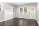 Bright living room with dark hardwood floors, fresh gray paint, and natural light from large windows at 2504 Yale Ave, Sanford, FL 32773