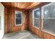 Charming wood porch with a matching wood ceiling and walls, featuring natural light from multiple windows at 2504 Yale Ave, Sanford, FL 32773