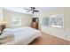 Bright bedroom with two windows, neutral walls, hardwood floors, and a ceiling fan at 2707 Chelsea St, Orlando, FL 32803
