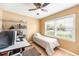 Cozy bedroom featuring natural light from the window, with desk, shelving unit and twin bed at 2707 Chelsea St, Orlando, FL 32803