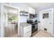 Modern kitchen featuring stainless steel appliances, white cabinetry, and sleek countertops providing a modern feel at 2707 Chelsea St, Orlando, FL 32803