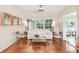 Bright living room featuring hardwood floors, large windows, and modern furniture at 2707 Chelsea St, Orlando, FL 32803