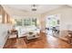 Sun-filled living room boasting wood floors, a white sofa, and a view into the adjoining dining area at 2707 Chelsea St, Orlando, FL 32803