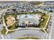 Community aerial view showcasing pool, clubhouse, playground, tropical palms and manicured lawns at 2934 Title St, Kissimmee, FL 34746
