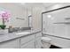 Well-lit bathroom features a modern vanity with gray counters and shower-tub combo at 2934 Title St, Kissimmee, FL 34746