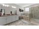 Spacious bathroom features a double vanity, shower, and soaking tub with tile surround at 2934 Title St, Kissimmee, FL 34746