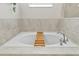 Relaxing soaking tub with tile surround and chrome fixtures, perfect for unwinding at 2934 Title St, Kissimmee, FL 34746