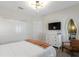 Bright bedroom features modern light fixture, dresser with television, and large decorative mirror at 2934 Title St, Kissimmee, FL 34746