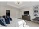 Bright bedroom features tray ceilings, carpet, a TV, and an ensuite closet and bathroom at 2934 Title St, Kissimmee, FL 34746