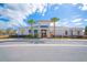 Community clubhouse with modern architectural details, palm trees, and landscaped grounds at 2934 Title St, Kissimmee, FL 34746