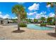 Inviting community pool area surrounded by lush landscaping, palm trees, and comfortable lounge seating at 2934 Title St, Kissimmee, FL 34746