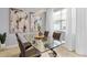 Dining room with a glass-top table, modern chandelier, neutral decor, and abundant natural light at 2934 Title St, Kissimmee, FL 34746