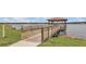 Picturesque wooden dock extends over the tranquil lake, offering a serene escape with covered area at 2934 Title St, Kissimmee, FL 34746