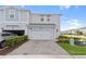 Charming townhouse featuring light-blue siding, a two-car garage, and a well-maintained brick-paved driveway at 2934 Title St, Kissimmee, FL 34746