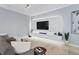 Modern living room with a large TV, sleek media console, plush sofa, and stylish decor at 2934 Title St, Kissimmee, FL 34746