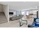 Open-concept living space with a modern kitchen, dining area, and cozy living room with neutral tones at 2934 Title St, Kissimmee, FL 34746