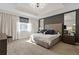 Modern main bedroom features a large window, neutral tones, carpet, and dark accent walls at 2934 Title St, Kissimmee, FL 34746