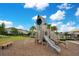 Community playground with wooden playset, slide, and bench seating for relaxation at 2934 Title St, Kissimmee, FL 34746