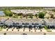 Street view showcasing modern townhomes with manicured lawns, paved driveways, and a retail store at 2934 Title St, Kissimmee, FL 34746