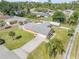 Aerial view of the home with a well-manicured lawn and driveway at 2945 Juniper Dr, Edgewater, FL 32141